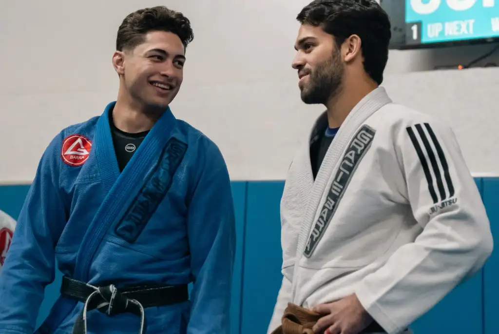 Two adult Jiu-Jitsu students talking on the mats at Gracie Barra Upland